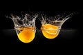 Group of fresh fruits falling in water with splash on black background Royalty Free Stock Photo