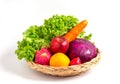 Group of fresh vegetables salad ingredients in basket on white background