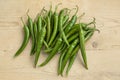 Group of fresh green chili peppers on wood