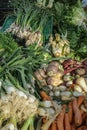 Group of fresh green vegetables on market stall with selective focus. Sunny morning at spanish weekly marketplace early spring Royalty Free Stock Photo