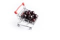 Group of fresh red cherries in a small shopping cart Royalty Free Stock Photo