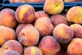 Group of fresh red peaches available for sale at a street food market, natural background, soft focus