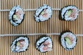 Group of fresh rolled sushi on bamboo sushi mat Royalty Free Stock Photo