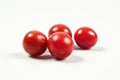 A group of fresh tomatoes sitting on a clean white surface, ready for use or display Royalty Free Stock Photo