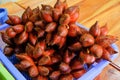 Group of freshness red salak or salacca zalacca fruit in blue basket on the table for sell in traditional market. sweet and sour t Royalty Free Stock Photo