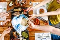 Group of Friend eating Mexican Tacos and traditional food, snacks and peoples hands over table, top view. Mexican cuisine