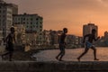 Group of friend jump into sea from wall in Havana, Cuba