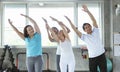 Group of friend senior stretching exercise at yoga gym with trainer. elderly healthy lifestyle