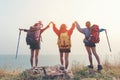 Group friend team asian young women of hikers walking adventure with backpack on a mountain at sunset. Traveler life going trip ca Royalty Free Stock Photo