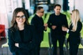 Group of friendly young businesspeople with happy female leader in front Royalty Free Stock Photo