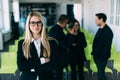 Group of friendly young businesspeople with happy female leader in front Royalty Free Stock Photo