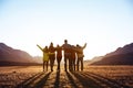 Group of friends against sunset mountains