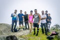 Group of friends arrive at the top of the mountain \