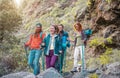 Group of friends with backpacks doing trekking excursion on mountain - Young tourists walking and exploring the wild nature Royalty Free Stock Photo