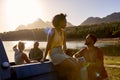 Group Of Friends With Backpacks In Pick Up Truck On Road Trip By Lake At Sunset Royalty Free Stock Photo