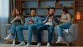 Group friends business people sit on couch with mobile phones chatting in social media ignoring each other multiethnic Royalty Free Stock Photo