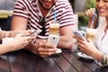 Group of friends in a cafe using smartphones Royalty Free Stock Photo