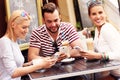 Group of friends in a cafe using smartphones Royalty Free Stock Photo