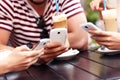 Group of friends in a cafe using smartphones Royalty Free Stock Photo