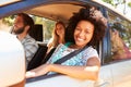 Group Of Friends In Car On Road Trip Together