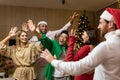 Group friends celebrate New Year& x27;s party at home dancing together Christmas eve having fun. house New Year party Royalty Free Stock Photo