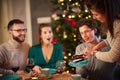 Group of friends celebrating Christmas at home with fancy cake Royalty Free Stock Photo