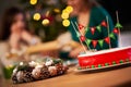 Group of friends celebrating Christmas at home with fancy cake Royalty Free Stock Photo