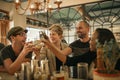 Group of friends cheering with drinks in a trendy bar Royalty Free Stock Photo