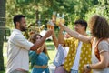 Group of friends clinking glasses at a garden party. Royalty Free Stock Photo