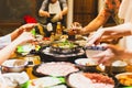 Group of friends cooking the Chinese shabu hotpot at home. Royalty Free Stock Photo