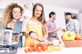 Group of friends cooking at home to have dinner together Royalty Free Stock Photo