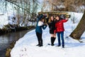 A group of friends do selfie in the winter near the river Royalty Free Stock Photo