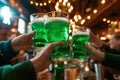 Group of friends drinking green beer at a bar. Toasting with glasses of alcoholic beverage. Celebrating St. Patrick\'s Day in Royalty Free Stock Photo