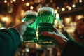 Group of friends drinking green beer at a bar. Toasting with glasses of alcoholic beverage. Celebrating St. Patrick\'s Day in Royalty Free Stock Photo