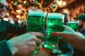Group of friends drinking green beer at a bar. Toasting with glasses of alcoholic beverage. Celebrating St. Patrick\'s Day in Royalty Free Stock Photo