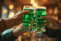 Group of friends drinking green beer at a bar. Toasting with glasses of alcoholic beverage. Celebrating St. Patrick\'s Day in Royalty Free Stock Photo