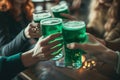 Group of friends drinking green beer at a bar. Toasting with glasses of alcoholic beverage. Celebrating St. Patrick\'s Day in Royalty Free Stock Photo