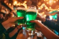 Group of friends drinking green beer at a bar. Toasting with glasses of alcoholic beverage. Celebrating St. Patrick\'s Day in Royalty Free Stock Photo