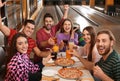 Group of friends with drinks and pizza in bowling Royalty Free Stock Photo