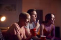 Group Of Friends With Drinks Sitting On Sofa At Home Watching Movie Together Royalty Free Stock Photo