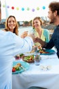 Group Of Friends Eating Meal On Rooftop Terrace Royalty Free Stock Photo