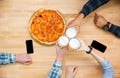 Group of friends eating pizza and drinking beer Royalty Free Stock Photo