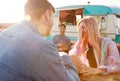 Group Of Friends Eating Takeaway Food From Truck At  Outdoor Music Festival Royalty Free Stock Photo