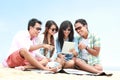 Group Friends Enjoying Beach Holiday together with tablet pc Royalty Free Stock Photo