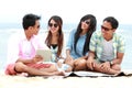 Group Friends Enjoying Beach Holiday together with tablet pc Royalty Free Stock Photo