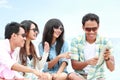 Group Friends Enjoying Beach Holiday together with tablet pc Royalty Free Stock Photo