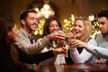 Group Of Friends Enjoying Evening Drinks In Bar