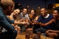 Group Of Friends Enjoying Night Out At Rooftop Bar Royalty Free Stock Photo