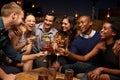 Group Of Friends Enjoying Night Out At Rooftop Bar Royalty Free Stock Photo