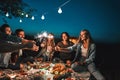 Group of friends enjoying out with sparklers. Young men and women enjoying with fireworks Royalty Free Stock Photo